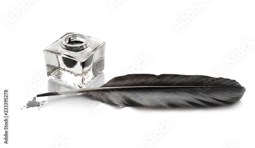 Feather pen and inkwell on white background