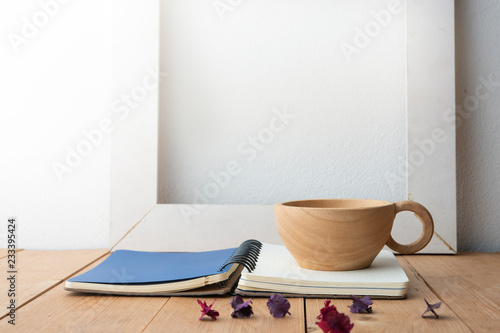 Still life details  cup of coffee with book on wood table