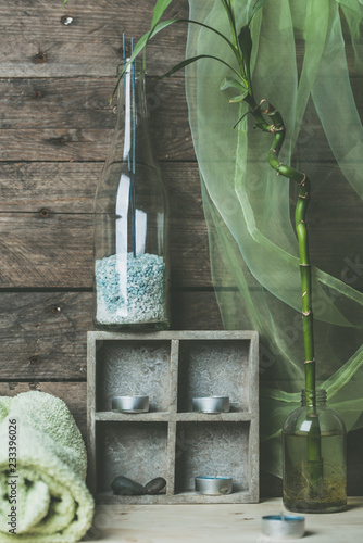 natural spa and wellness background, raw wood, candles, blue and green colors