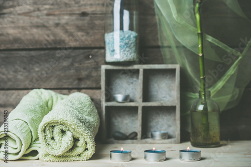 a moment to relax, natural spa and wellness background, raw wood, candles, blue and green colors