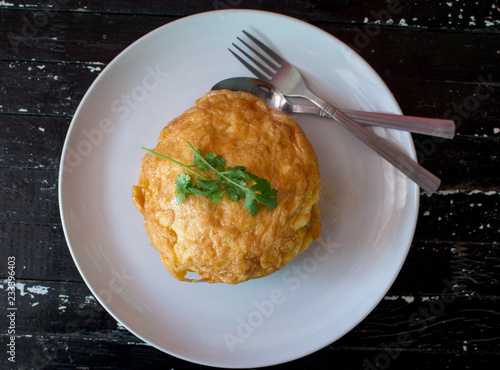 Rice with omelet ,Thai omelet rice on Wood Table photo