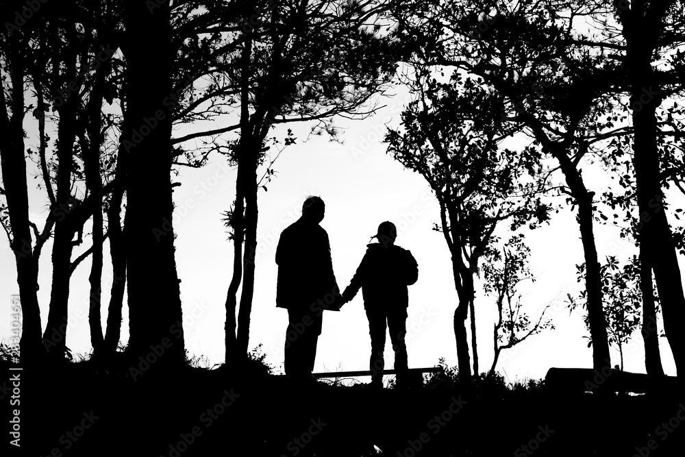 silhouette of love couple in trees border, back and white tone silhouette of love couple in trees border, back and white tone