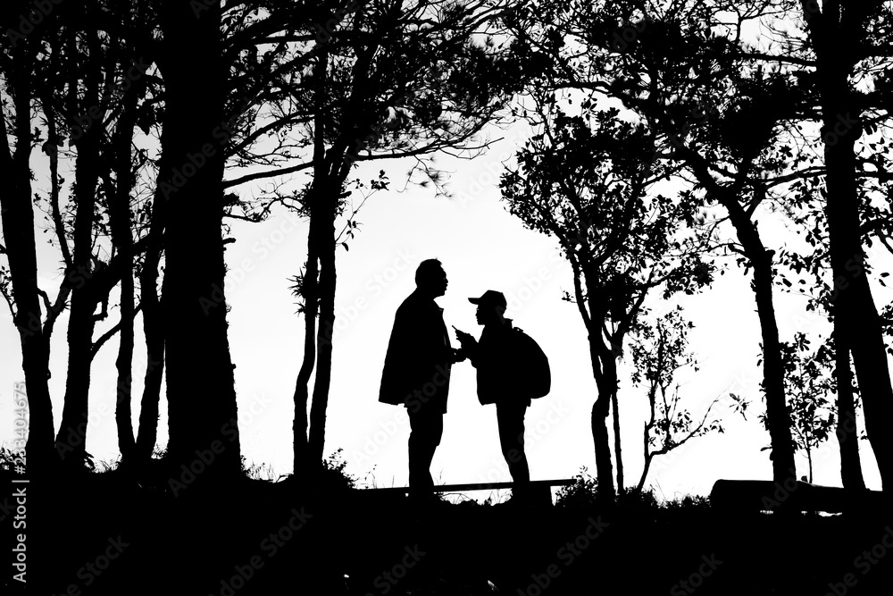 silhouette of love couple in trees border, back and white tone silhouette of love couple in trees border, back and white tone