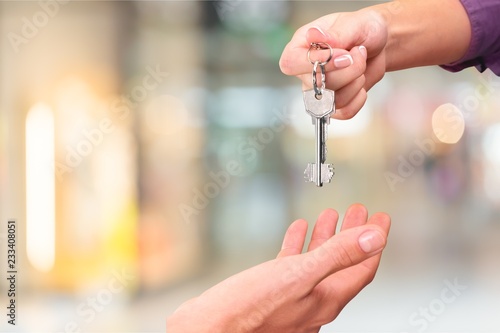 Hands of young couple with key