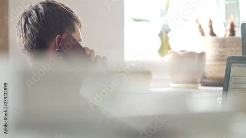 The Manager communicates by phone with the client in the office