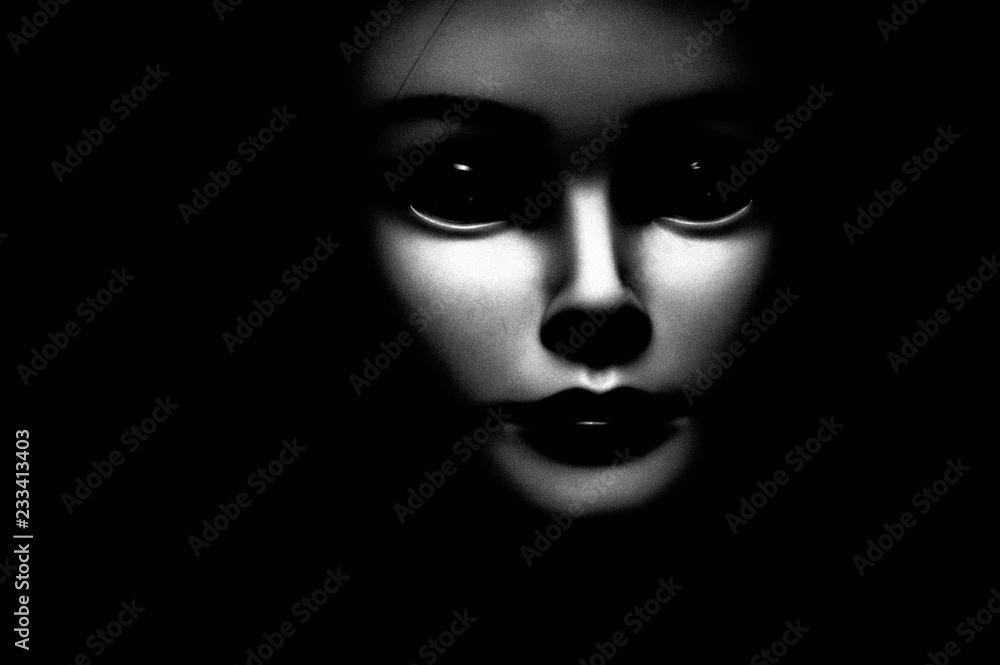 Close up of a spooky looking black eyed child looking passed viewer, featuring oversized black eyes, pale skin and black background. Close up of a spooky looking black eyed child looking passed viewer, featuring oversized black eyes, pale skin and black background.