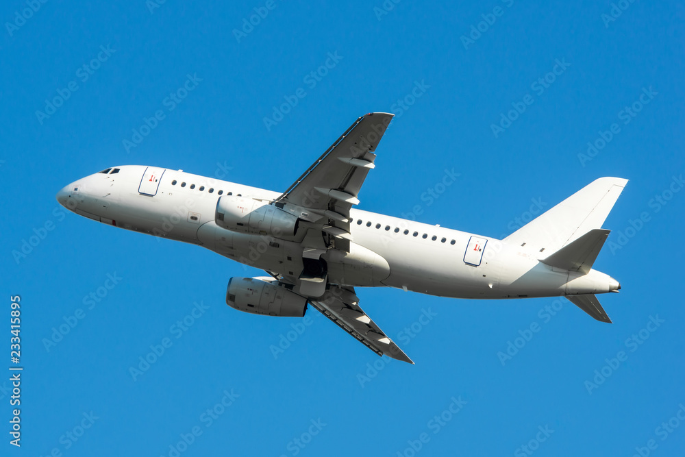 Modern white civilian airplane in the blue sky Modern white civilian airplane in the blue sky