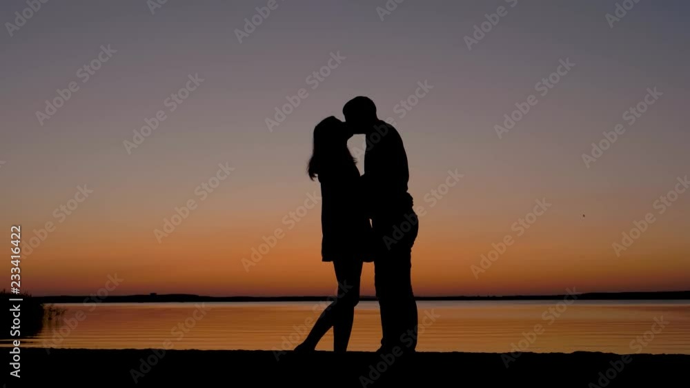 Silhouette Of Couple Men And Women Kissing At Romantic Sunset On The Sea Beach Silhouette Of Couple Men And Women Kissing At Romantic Sunset On The Sea Beach
