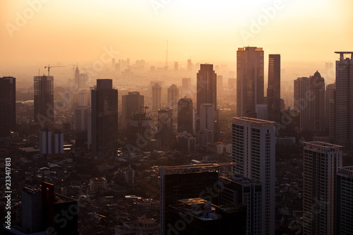 Aerial view of a hazy sunset over the skyline of downtown Jakarta Indonesia © SIX60SIX