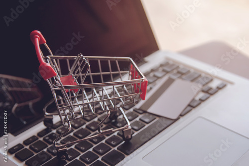 Shopping online concept - Shopping service on The online web. offers home delivery. Empty shopping cart on a laptop keyboard