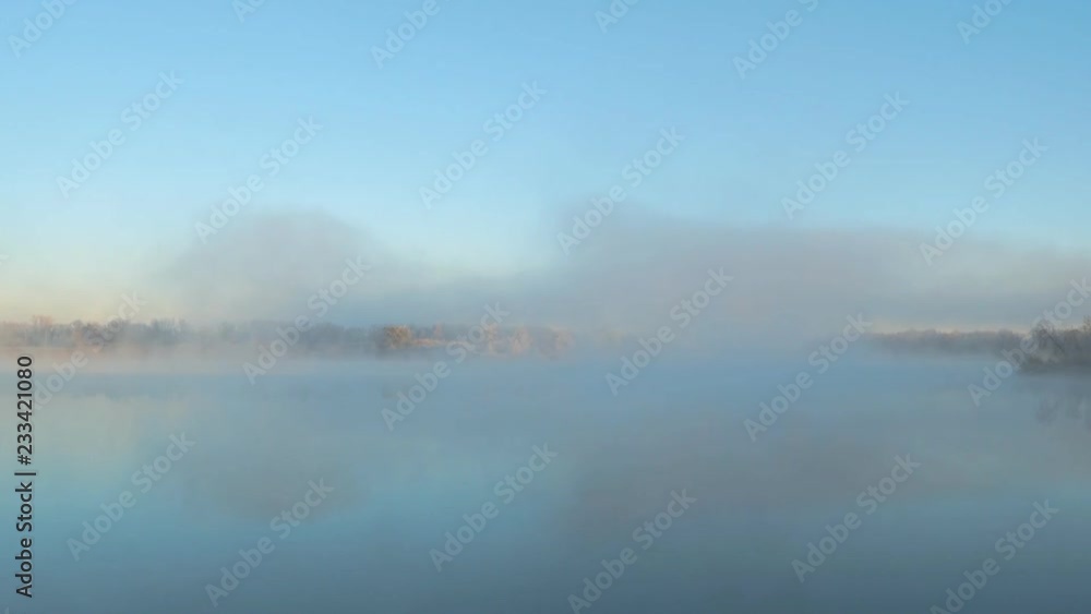 Morning fog on the lake in the frosty morning. Early winter, sunrise Morning fog on the lake in the frosty morning. Early winter, sunrise