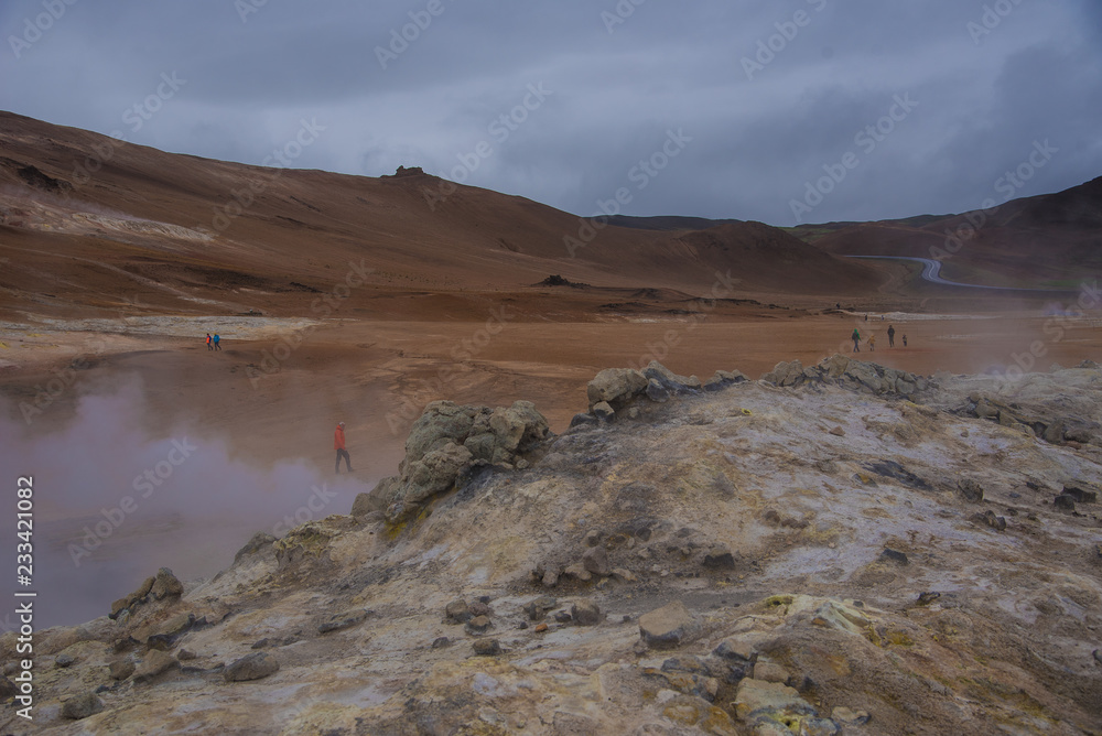 Tourists explore a geothermal area in Iceland