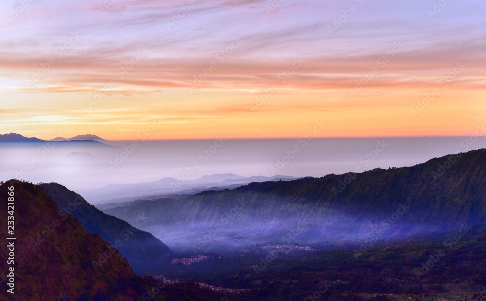 Naklejka premium Morning in the Bromo Tengger Semeru National Park. Dense fog in the valley between volcanoes, Java Island, Indonesia