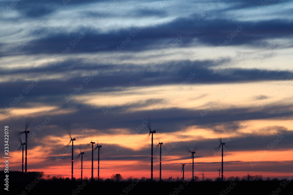 sunset landscape mit red horizon and wind power energy