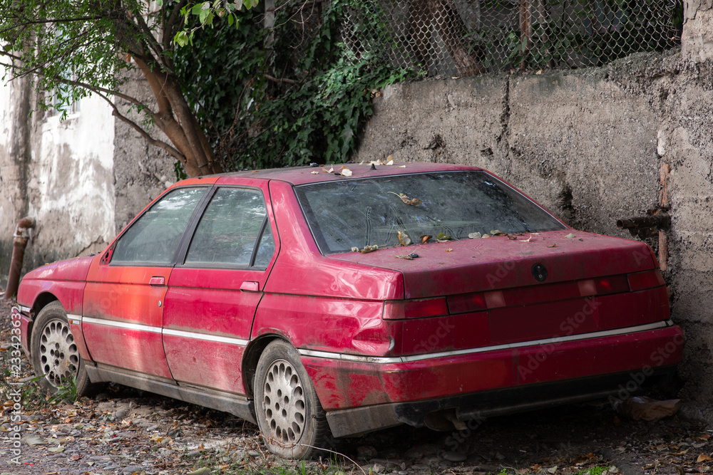 Old rusted car abandoned outdoors after crash Old rusted car abandoned outdoors after crash