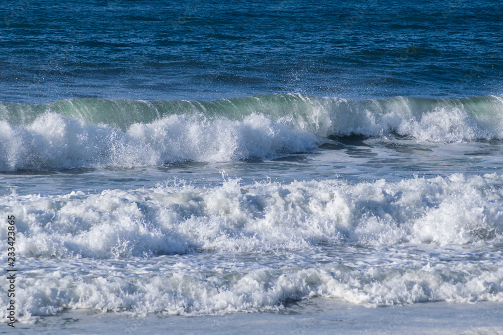 sea waves breaking on the shore of the beach splashing and forming foam sea waves breaking on the shore of the beach splashing and forming foam