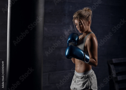 Sexy girl boxer trains in boxing hall