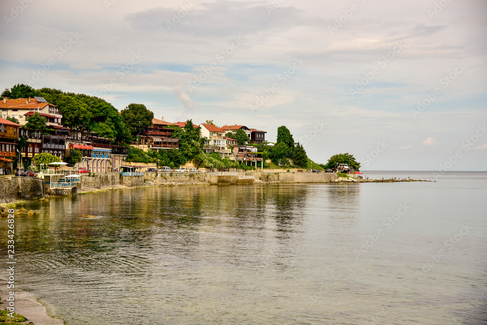 View of the seaside promenade with small cozy houses and water Bulgaria old Nessebar