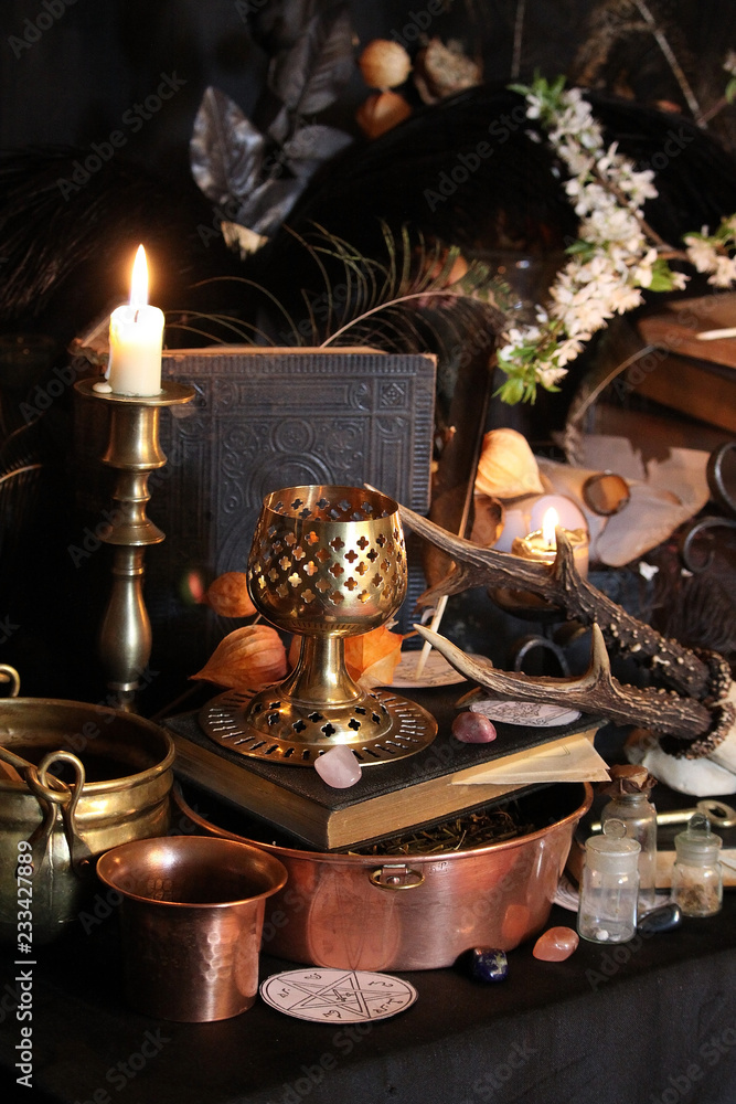 Black candle Magic Ritual. Antique Magic Book. Witchcraft Peacock feathers and candle background. Black candle Magic Ritual. Antique Magic Book. Witchcraft Peacock feathers and candle background.