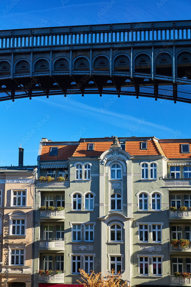 Metal structure of footbridge and facade of Art Nouveau tenement house in Poznan.