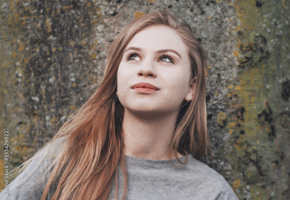 Portrait of a nice romantic girl on the background tree. Looking up. Youth culture. Fashion for young people. Energetic ambitious girl. Portrait of a nice romantic girl on the background tree. Looking up. Youth culture. Fashion for young people. Energetic ambitious girl.