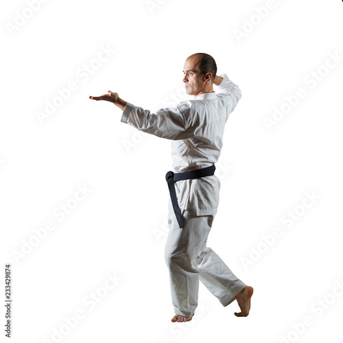 Athlete trains formal exercises on an isolated white background.