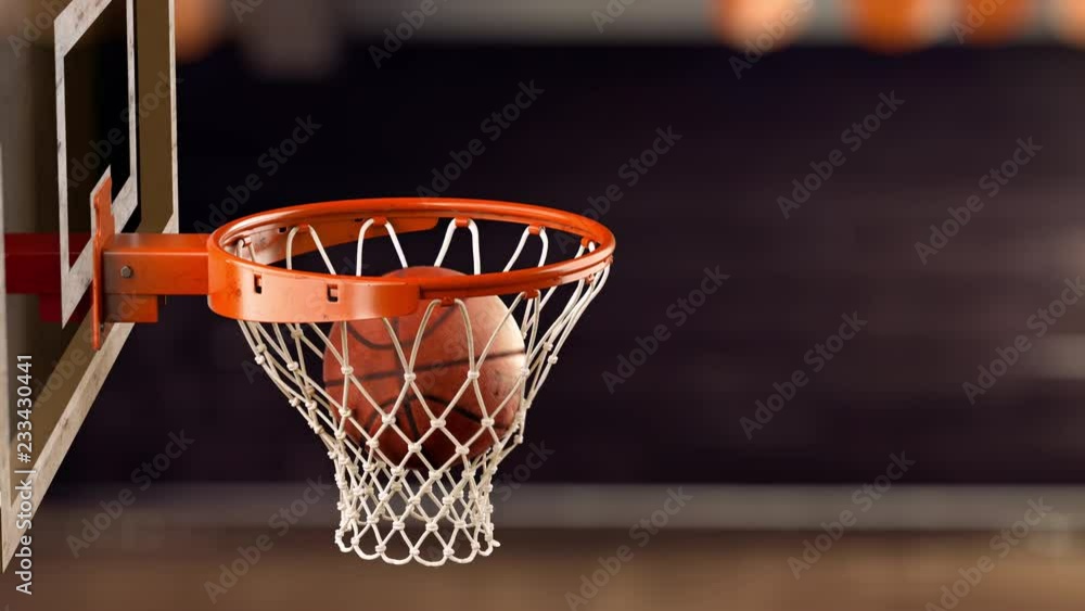 A beautiful throw basketball ball in a ring on the basketball arena A beautiful throw basketball ball in a ring on the basketball arena