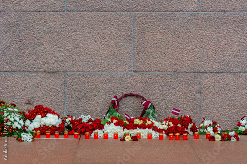 Wallpaper Mural Latvia 100 years. Red and white flowers compositions at the Freedom Monument in city Riga, Latvia Torontodigital.ca