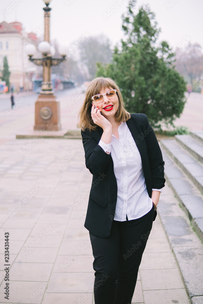 business woman with phone walk in the city