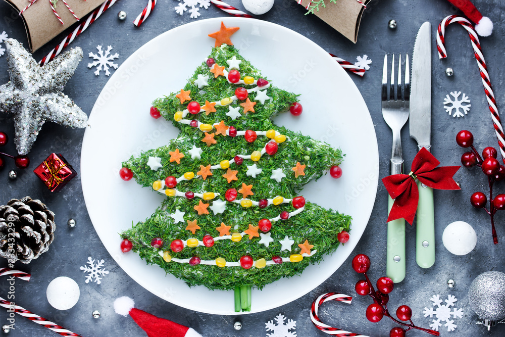 Christmas new year meal idea - creative appetizer salad like a christmas tree with festive decoration from greens and vegetables Christmas new year meal idea - creative appetizer salad like a christmas tree with festive decoration from greens and vegetables