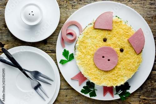 Russian salad olivier shaped yellow pig as a symbol of new year 2019