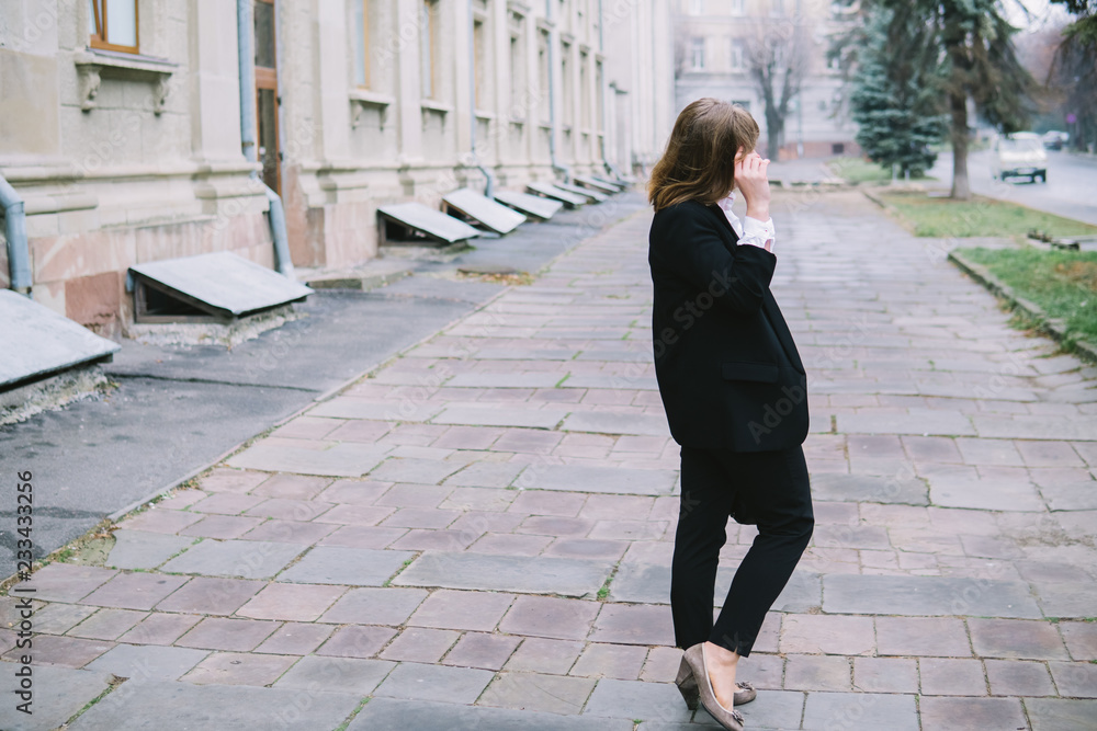 Business Women Style. Woman Going To Work Walking Downstairs. Portrait Of Beautiful Smiling Female In Stylish Office Clothes Going Old Town. Business Women Style. Woman Going To Work Walking Downstairs. Portrait Of Beautiful Smiling Female In Stylish Office Clothes Going Old Town.