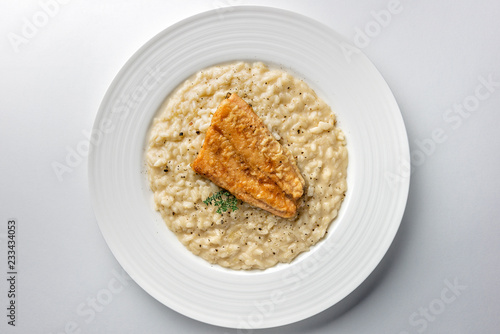 Dish of Parmesan risotto with fish fillet