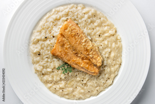 Dish of Parmesan risotto with fish fillet