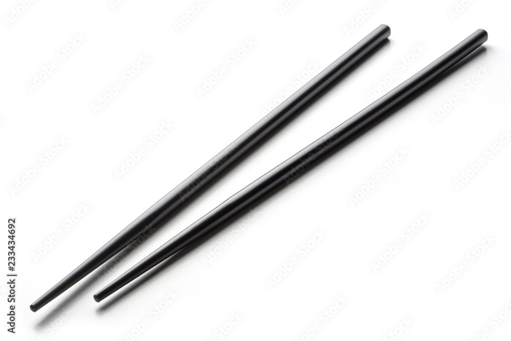 Black chopsticks on a white background