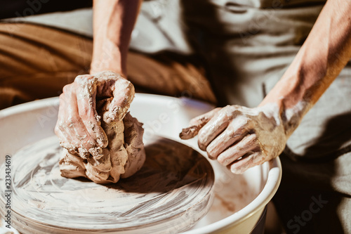 Obraz na plátne Artisan potter prepares material clay for pottery