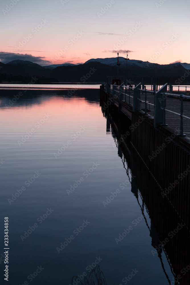 Lake and dock at sunset