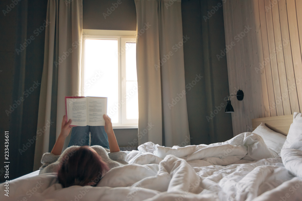 Girl reading a book in bedroom Girl reading a book in bedroom