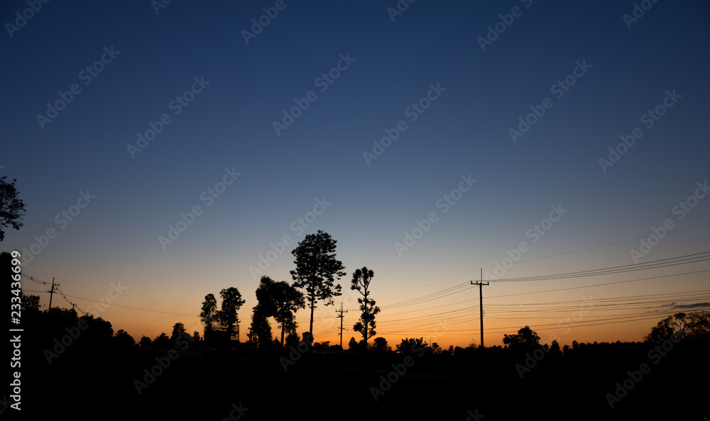 Landscape of power line with sun rise and blue sky background silhouette picture Landscape of power line with sun rise and blue sky background silhouette picture