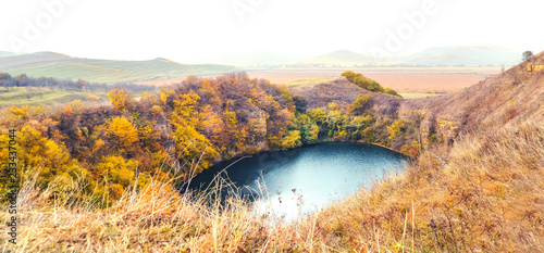 Mountain lake landscape. Reflection with autumn trees.The lake is karst origin, Shadhurey, North Caucasus, Kabardino Balkariya.  photo