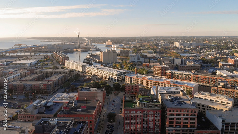 Fototapeta premium Milwaukee river in downtown, harbor districts of Milwaukee, Wisconsin, United States. Real estate, condos in downtown. Aerial view, drone flying