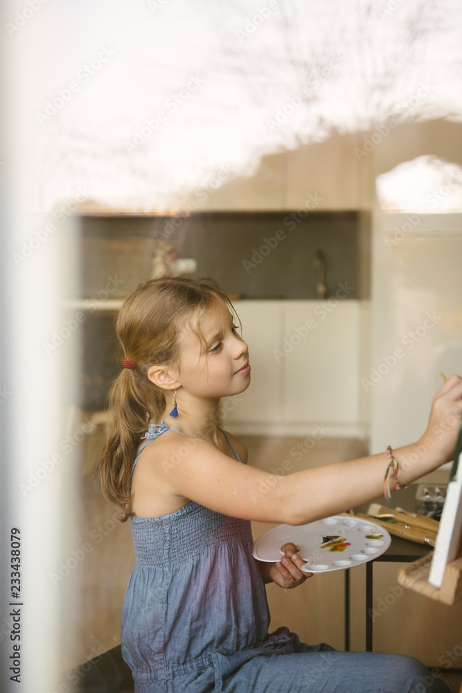 Little girl drawing on canvas at home Little girl drawing on canvas at home