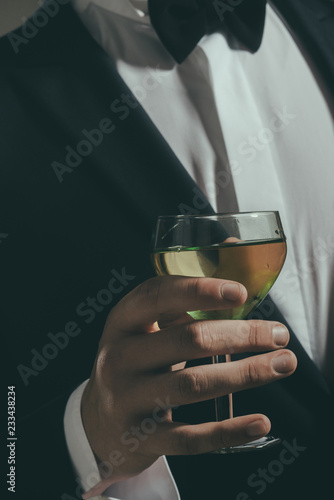 wedding. Bride groom on husband with glass. formal male fashion. successful business meeting. Deal. man drink wine. chears. To us. white wine in glass. true taste