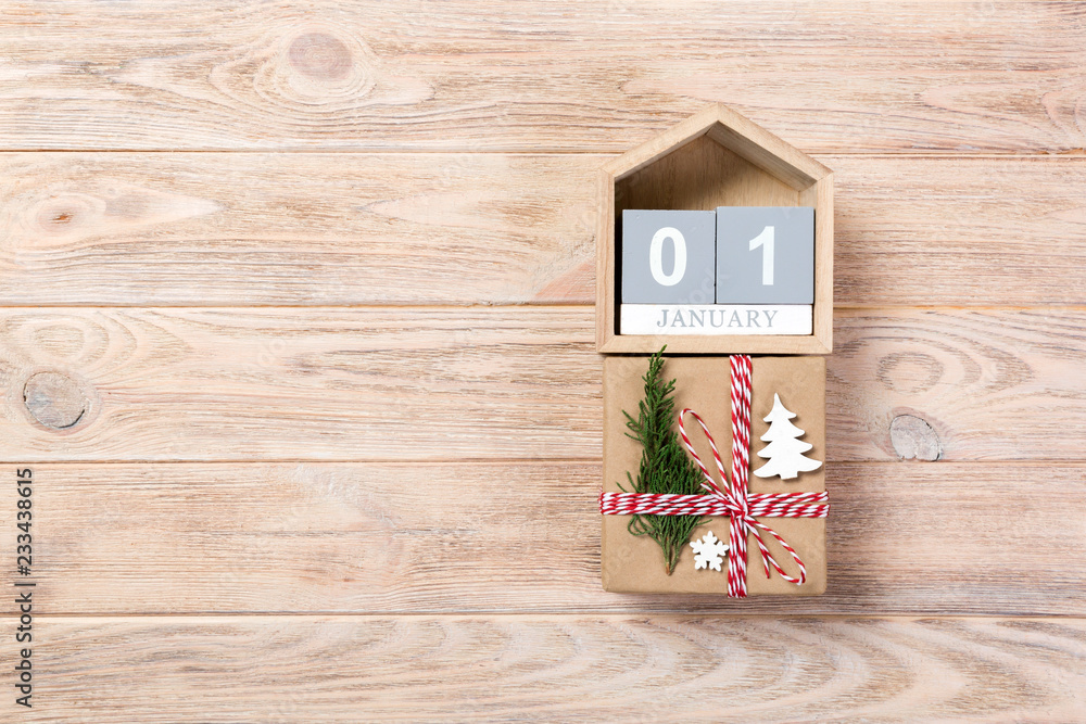 Calendar with date 1 january and gift boxes on color background. Christmas concept
