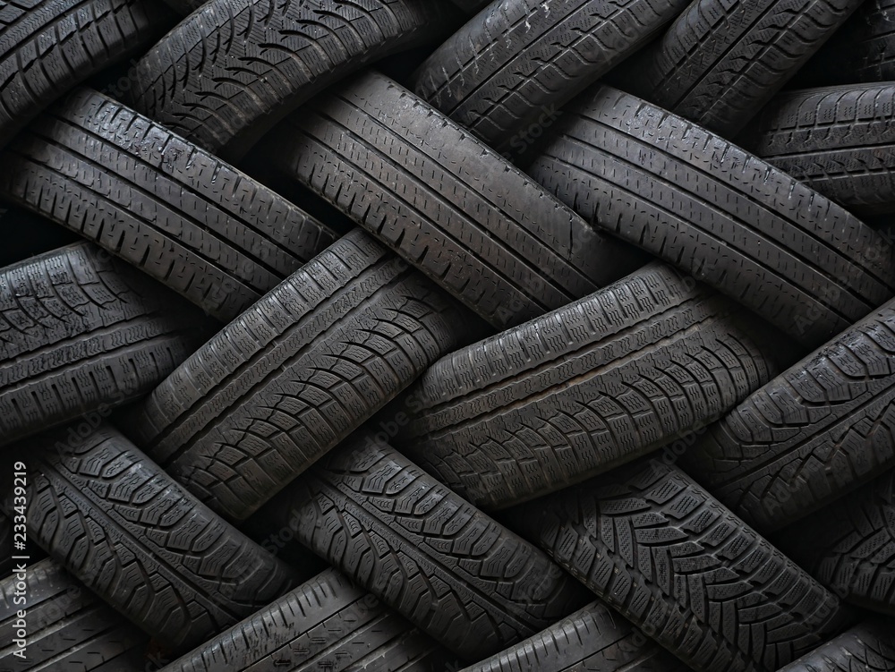 Used auto tires stacked in piles. - obrazy, fototapety, plakaty 
