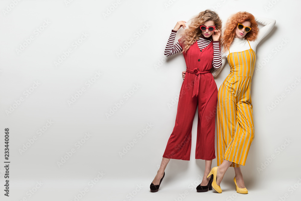 Two Gorgeous Girl in Fashion Outfit. Curly Hair