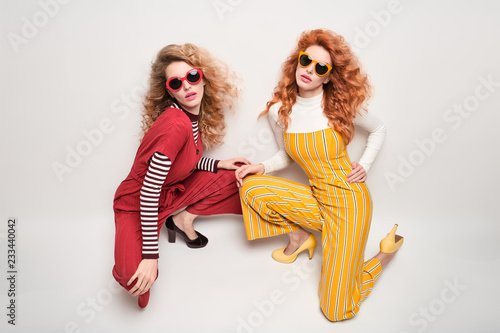 Two Gorgeous Girl in Fashion Outfit. Curly Hair photo