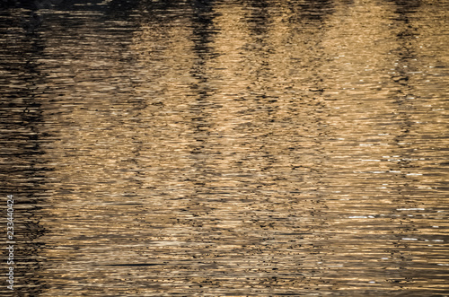 Reflection on water during sunrise in harbor in Oxnard, California