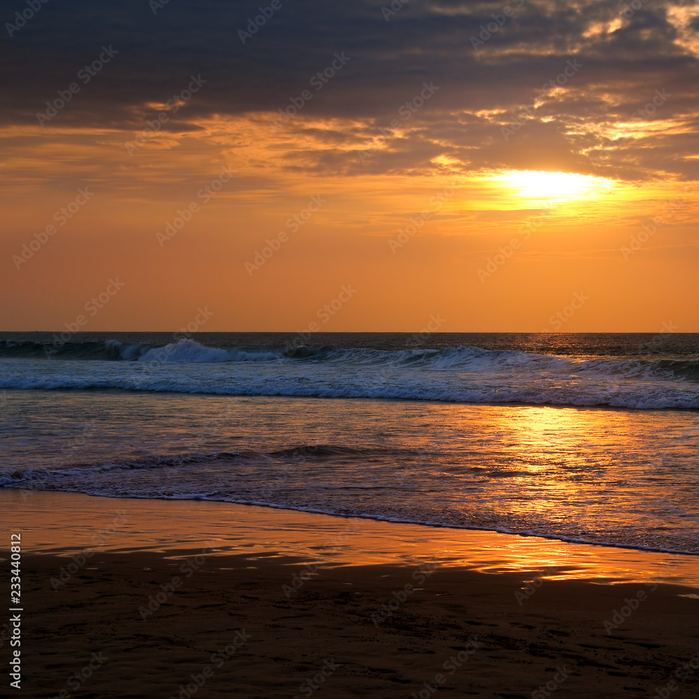 Beach of the ocean and golden sun rise.