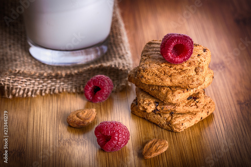 Oatmeal cookies with raspbarry and milk in a glass, healthy snac photo